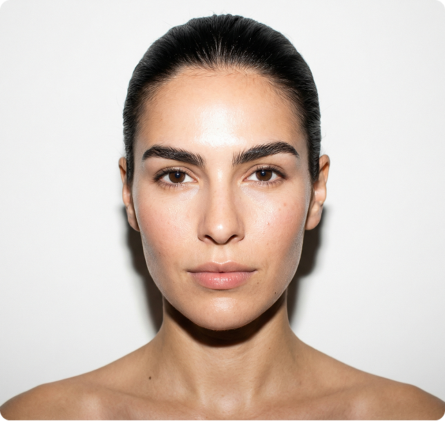 Woman with glowing skin holding a yellow Moisturizer Base bottle.