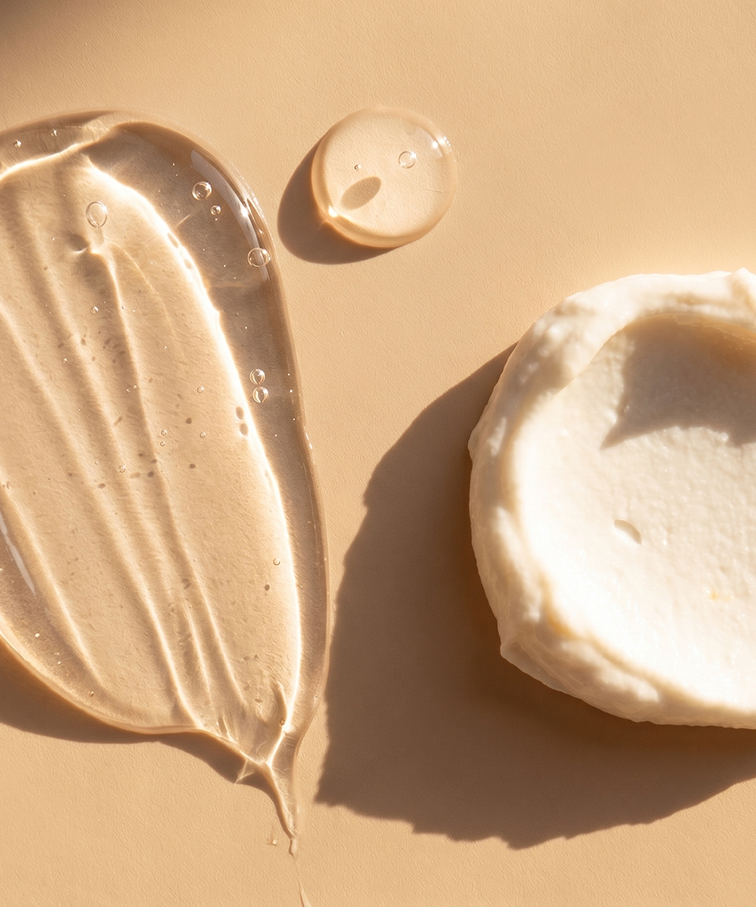 Close-up of skincare gel and cream textures on a warm beige background.